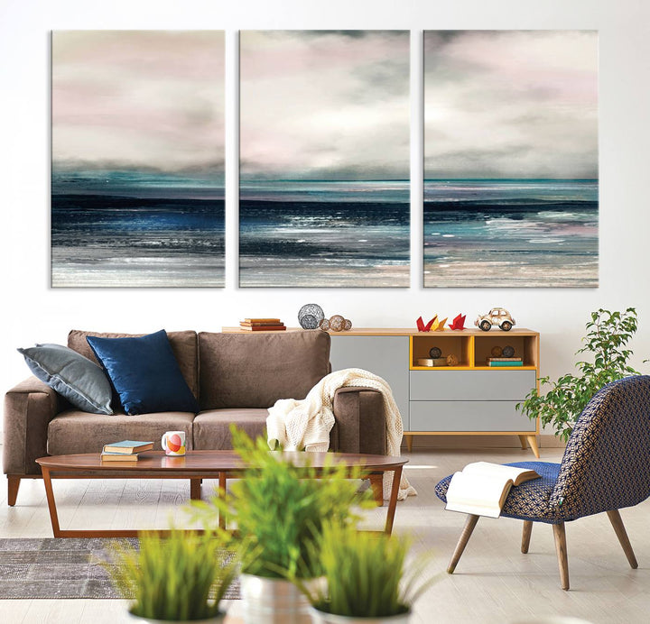 A contemporary abstract wall art canvas print in pastel pink, teal, and gray tones hangs on the wall.