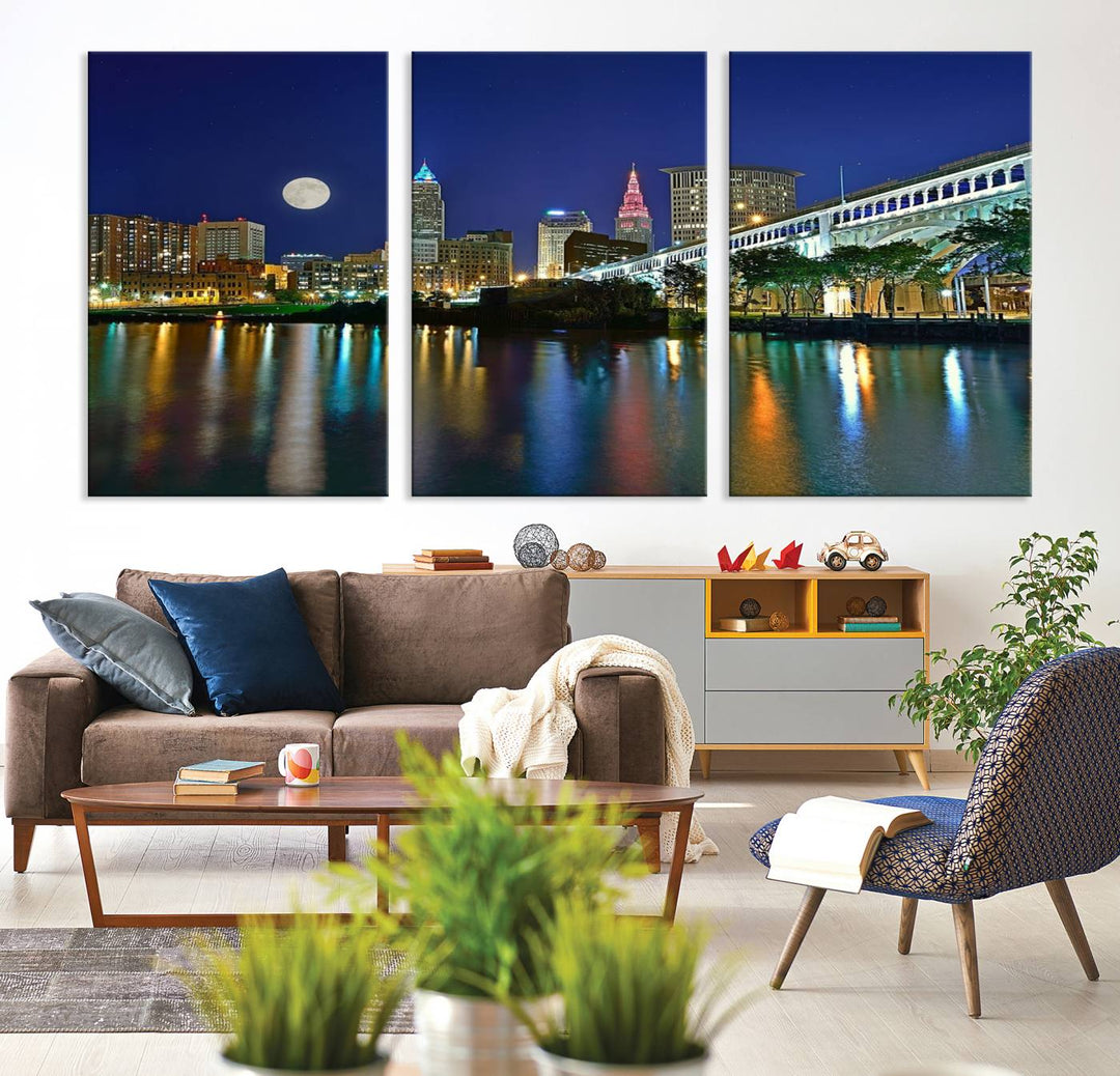 Cleveland City Lights Night Skyline Wall Art canvas showcases a moonlit cityscape reflected on water.