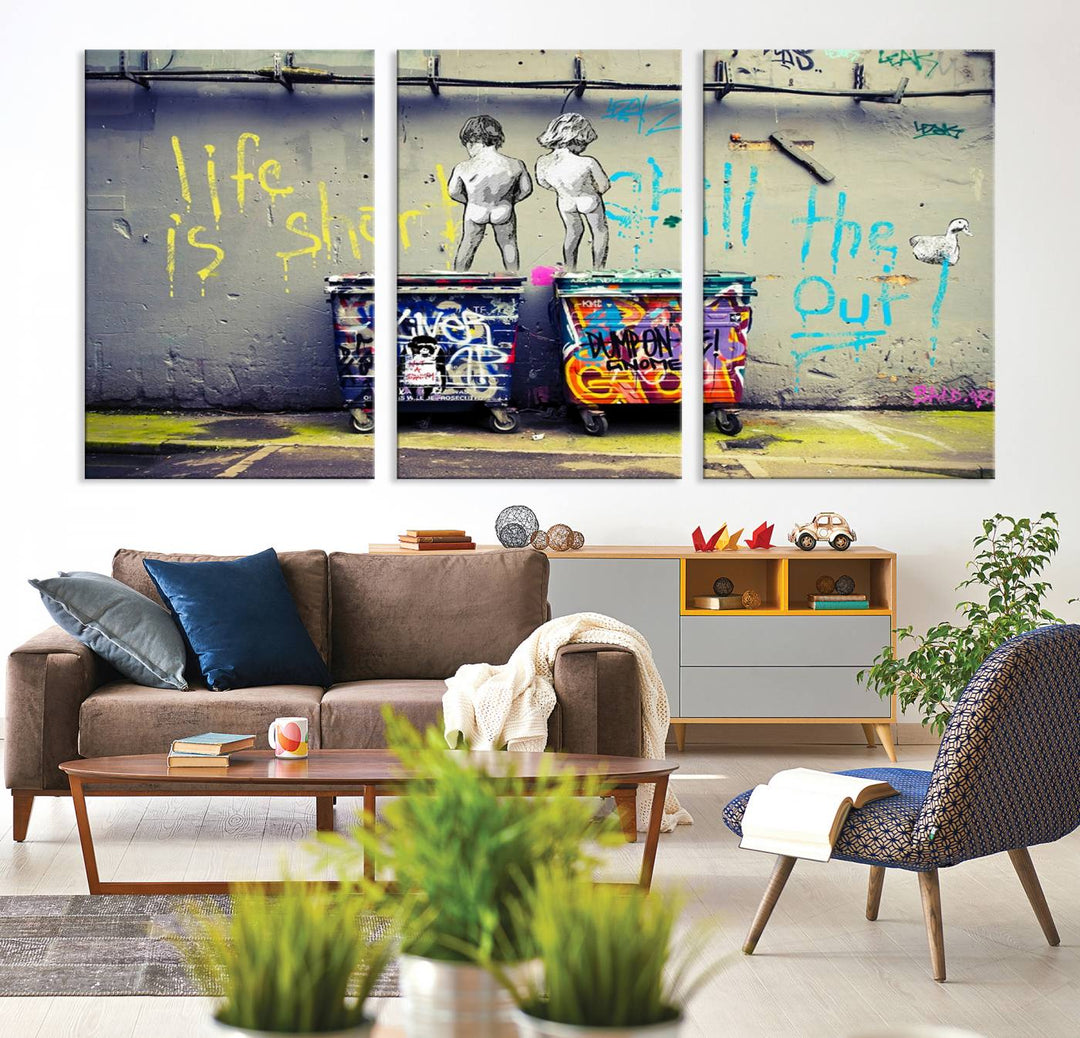 Banksys Life is Short graffiti, featuring kids and text, decorates the wall as a striking piece of framed canvas art.