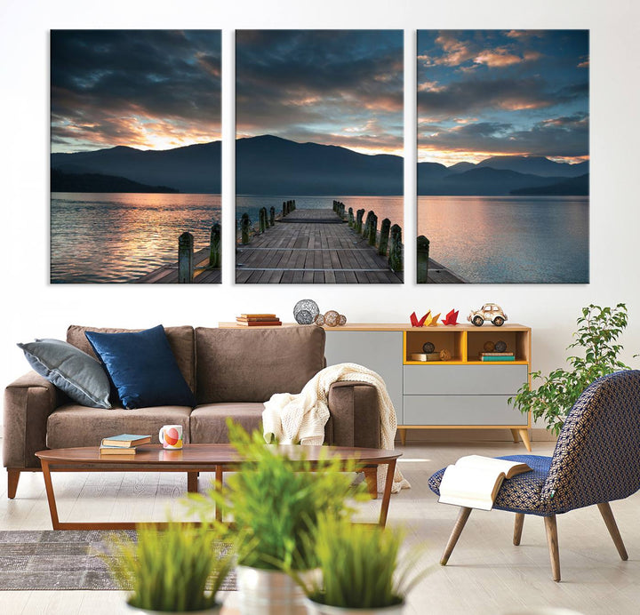 The Mountain Lake Wood Pier Canvas Wall Art depicts a serene lake and mountains, enhancing the beauty of any space.