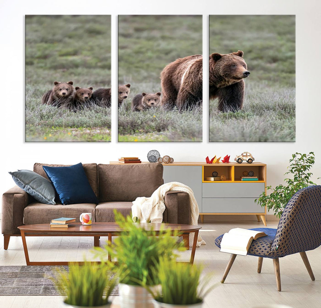 The large canvas print titled "Queen of the Tetons, 399 Grizzly Bear Cubs" showcases majestic wildlife photography of a bear and her cubs walking through the grass. This stunning canvas wall art, handmade in the USA, adds a charming touch to any room with its rustic decor appeal.