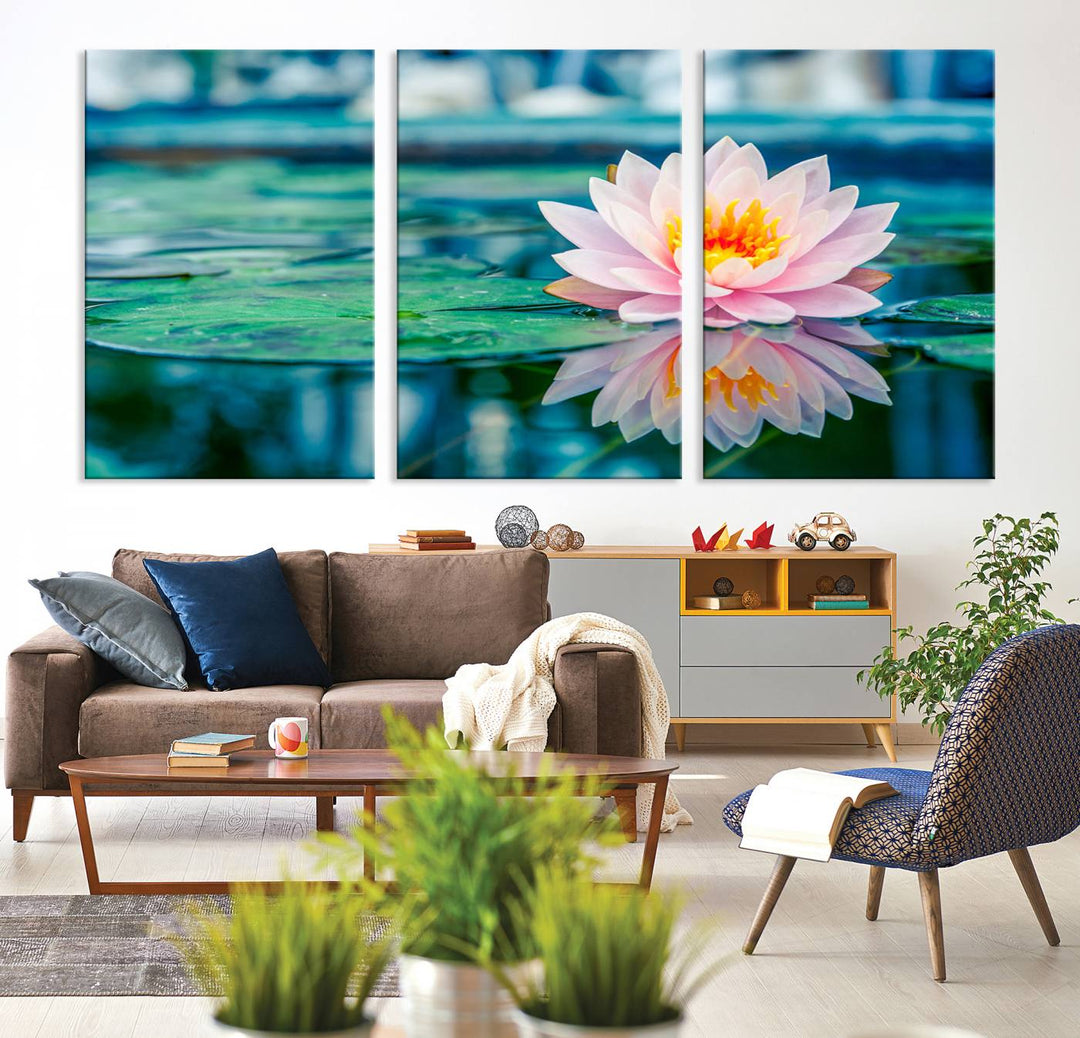 The Lotus Flower Canvas Print showcases a pink water lily with a yellow center gracefully floating on a calm pond.