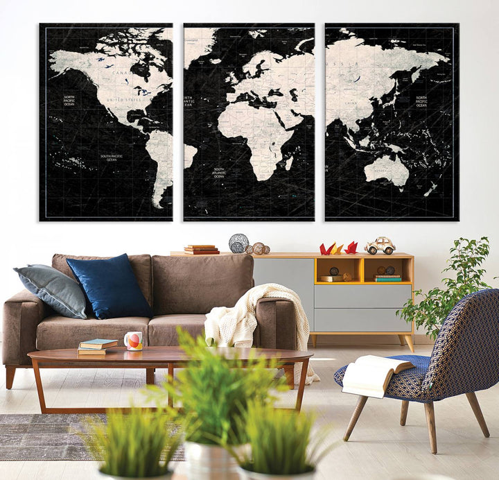 A bold global style framed black and white world map canvas print, presented in three panels, perfect for modern home or office decor.