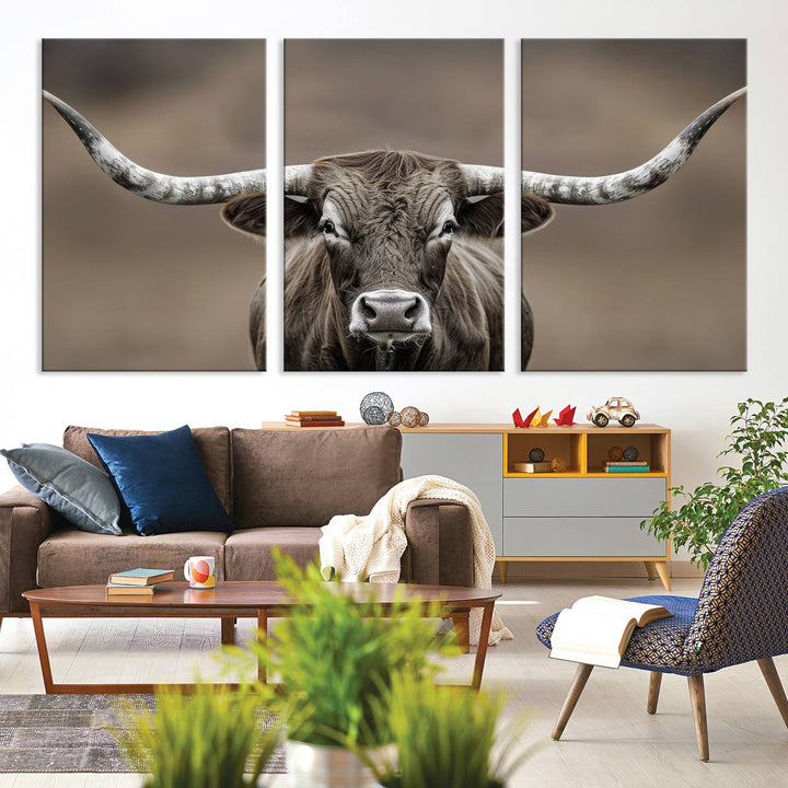 A close-up of a longhorn bull facing forward is featured in the Framed Texas Test-1, set against a blurred brown background.