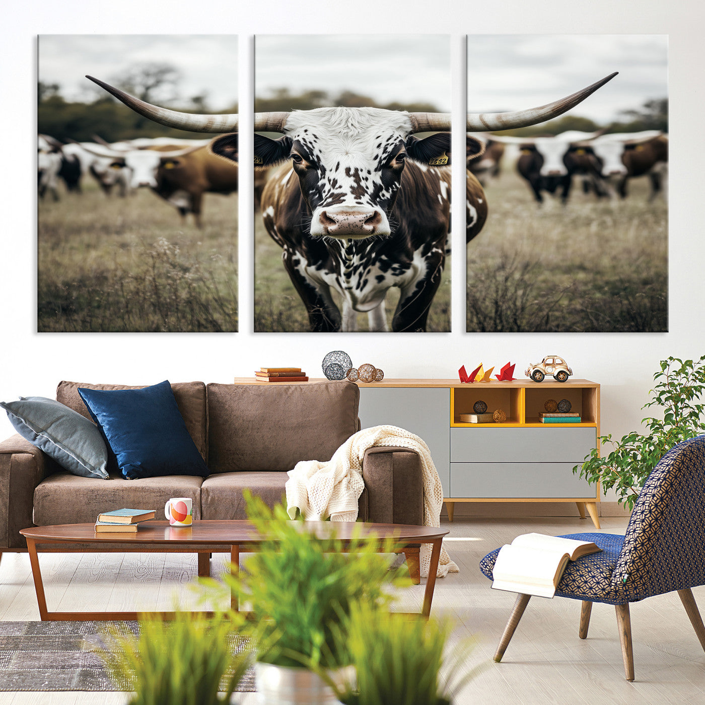 Canvas of a speckled Texas longhorn standing boldly in a field with a herd behind, perfect for rustic western or farmhouse wall decor.
