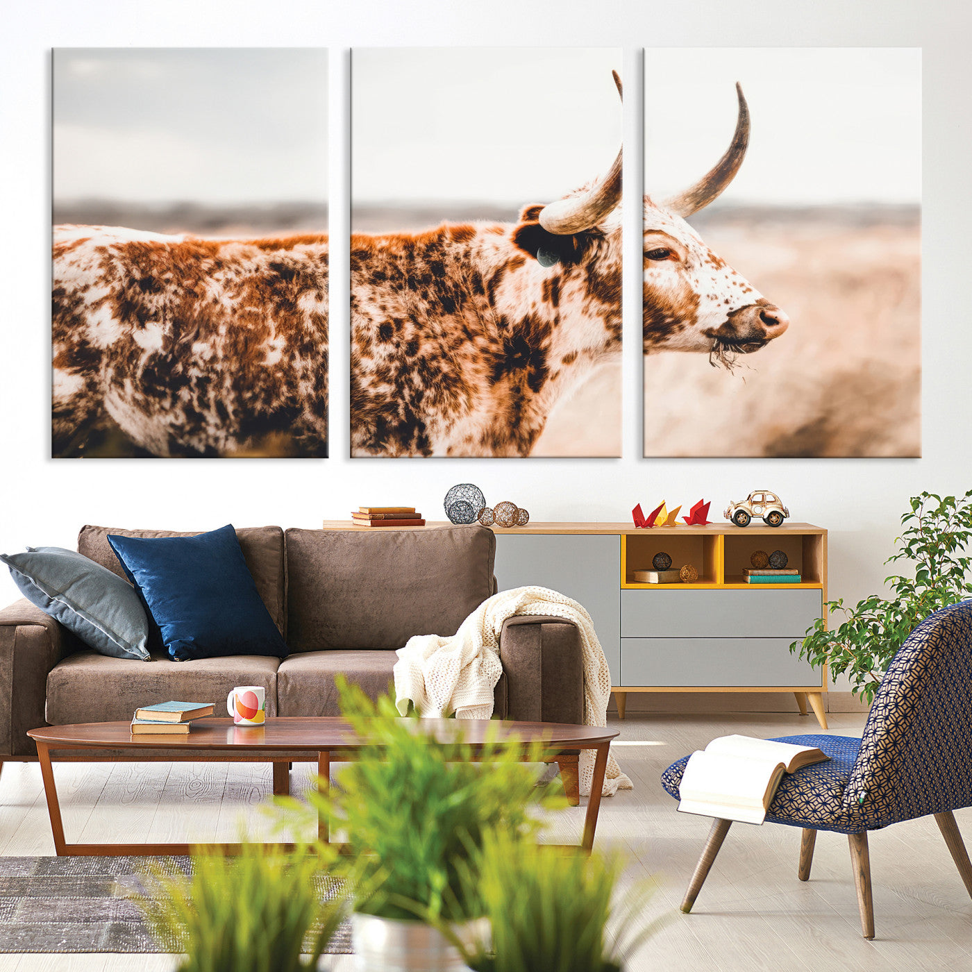 Speckled Texas longhorn with curved horns standing in a warm-toned prairie, perfect for rustic or country-style home decor.