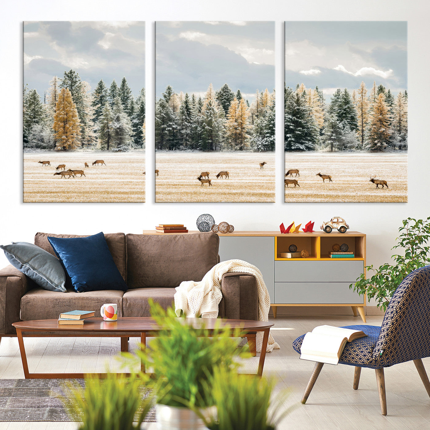 Elk herd in a snowy field with golden pine trees and frosted evergreens, ideal for neutral rustic or cabin-style home decor.