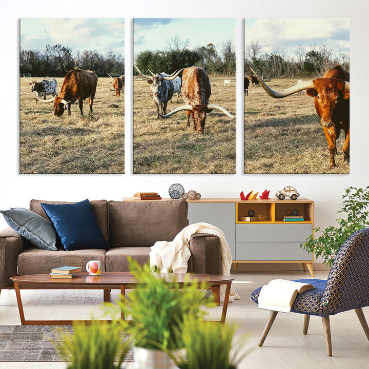 A herd of Texas Longhorn cattle grazing in an open field under a partly cloudy sky, capturing a rustic and Western ranch aesthetic.
