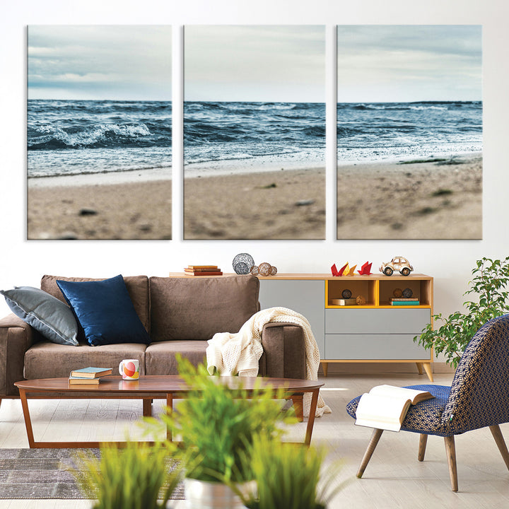 A moody ocean scene with gentle waves washing onto a sandy beach under a cloudy sky, creating a peaceful and coastal atmosphere.