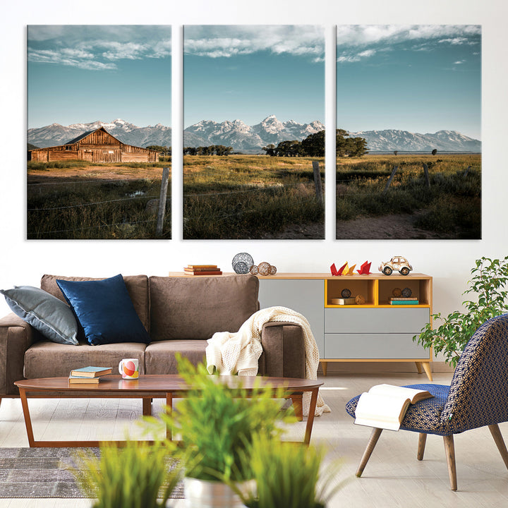 A rustic farmhouse with a wooden barn set against majestic mountain peaks under a soft blue sky, evoking peaceful countryside charm.