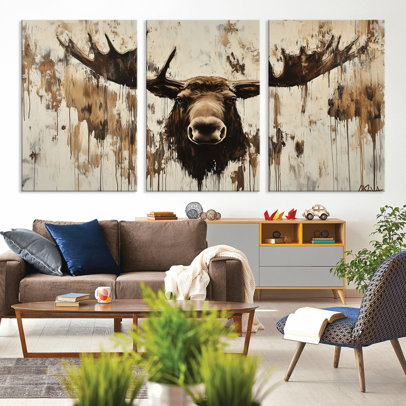 Expressive painting of a moose head with wide antlers in dark brown and beige tones, featuring paint drips and splatters on a light textured background, creating a striking rustic wall art canvas.