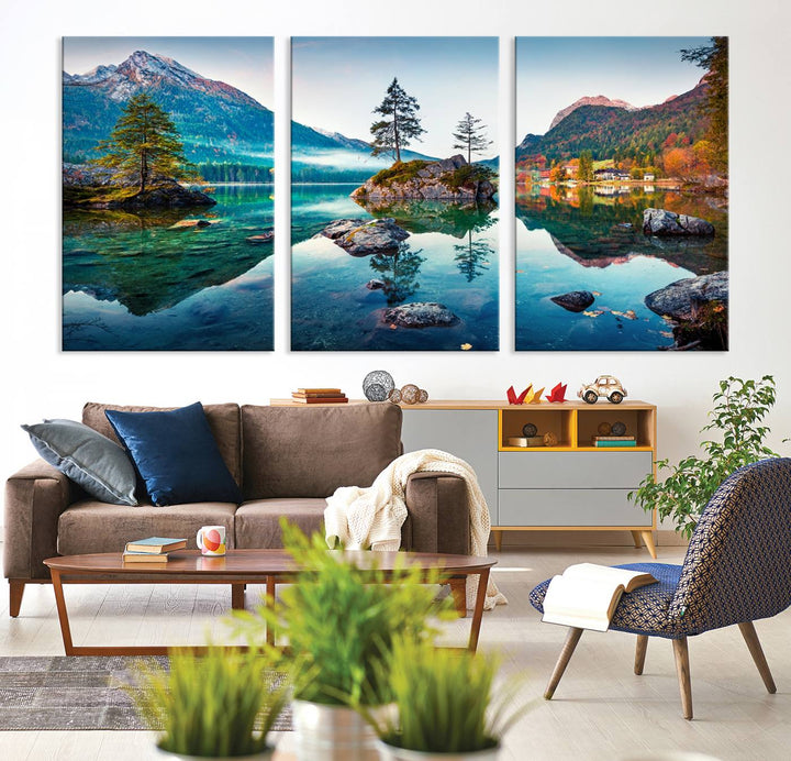 The 3-panel wall art showcases a serene mountain lake with rocky islands and trees, creating an ideal focal point for dining rooms or offices.