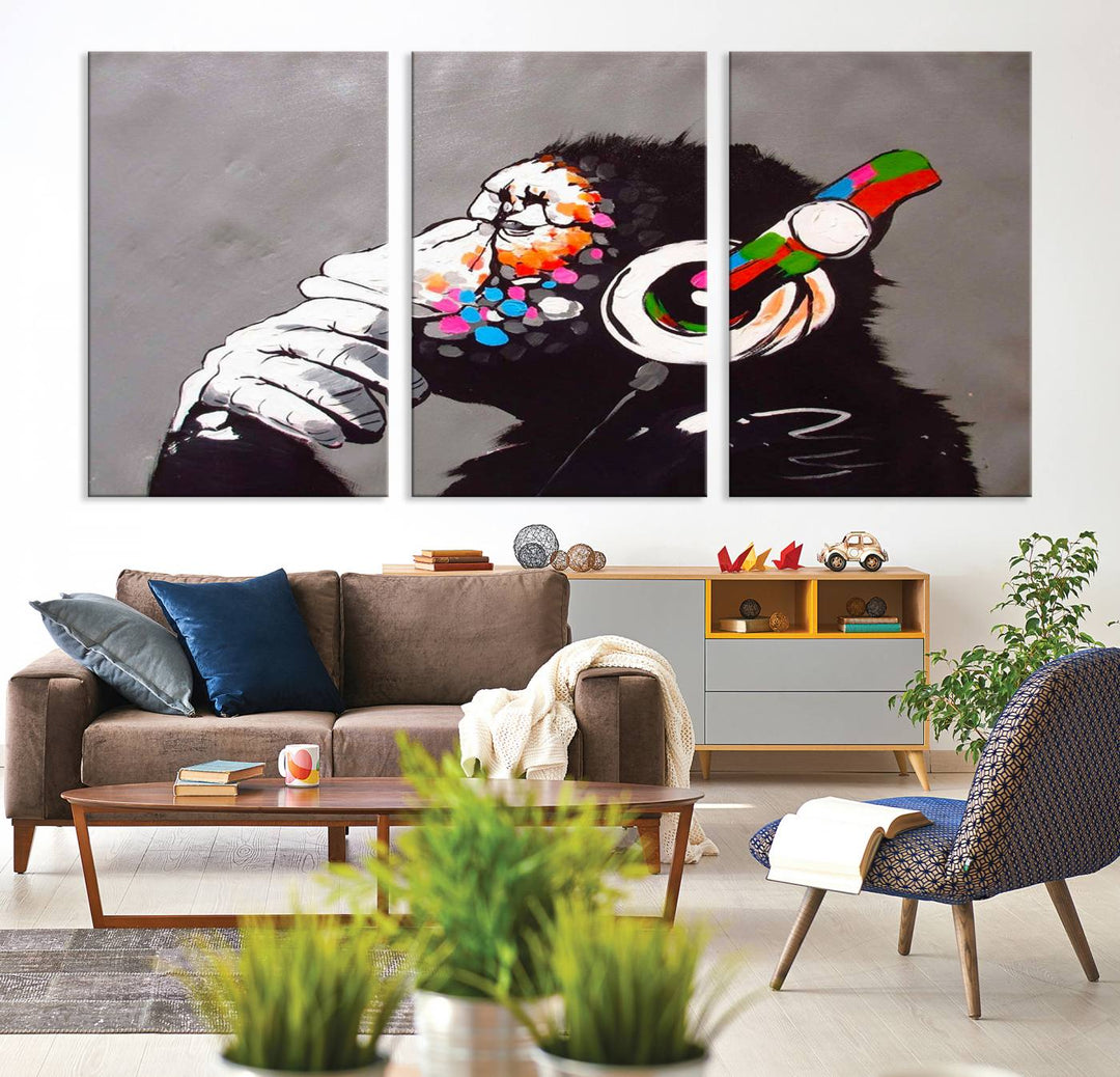 A vibrant triptych, the "DJ Monkey Listening to Music" wall art print, features a Banksy-inspired large canvas adorned with colorful modern pop art. This striking piece elegantly enhances the room with its dynamic and lively depiction.