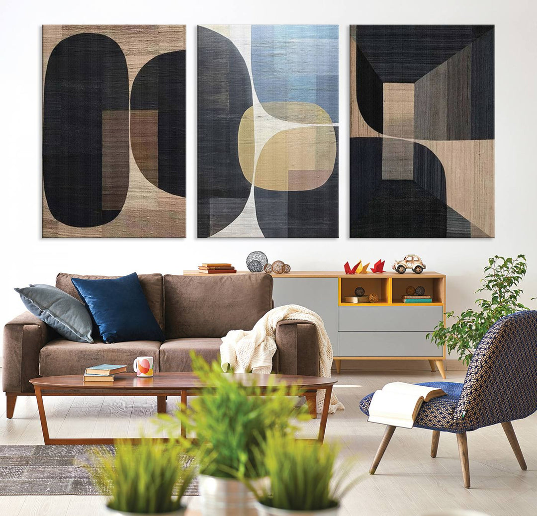 Abstract geometric wall art featuring black, gray, beige, and blue tones framed in a wooden border.