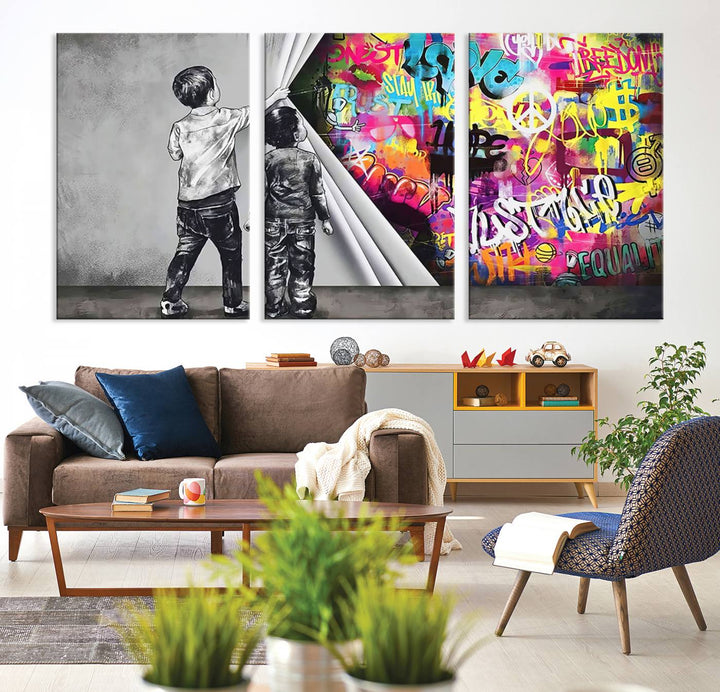 The Banksy Print - Street Art Canvas features a vibrant and bold image of two children lifting a curtain to reveal colorful graffiti. It's ready to hang, adding an urban modern decor vibe.