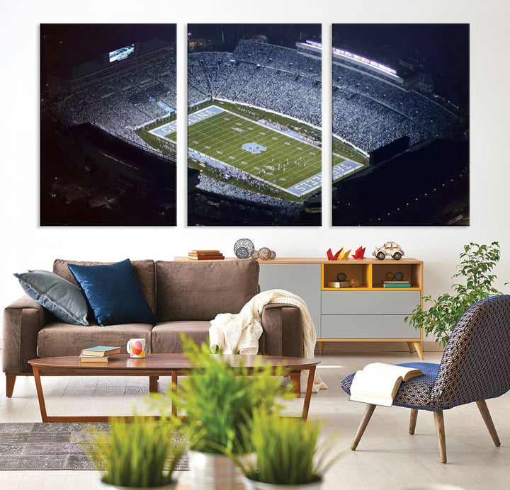 A University of North Carolina Tar Heels Football Team Print, showcasing Chapel Hill's Kenan Memorial Stadium, hangs in a modern dining room, adding a gallery-quality finish that enhances the entire space.