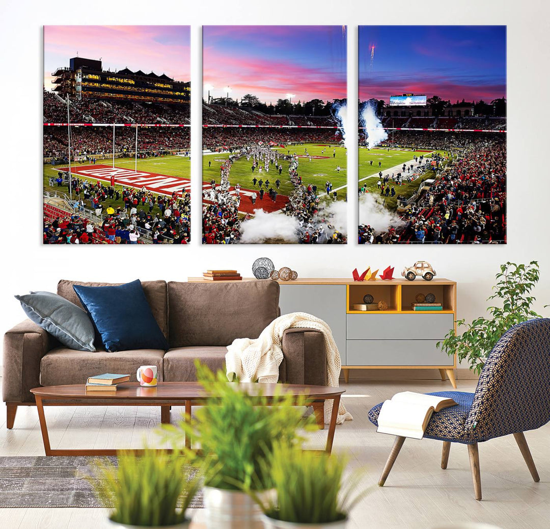 The wall art features a canvas print of the Stanford Cardinal football team, capturing players, fireworks, and smoke against the backdrop of a sunset at Stanford Stadium.