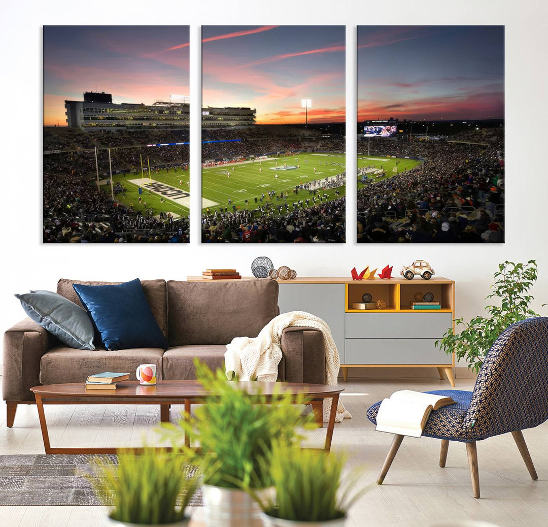 This wall art canvas print captures UCONN Huskies fans energizing a sunset scene at East Hartfords Pratt & Whitney Stadium.