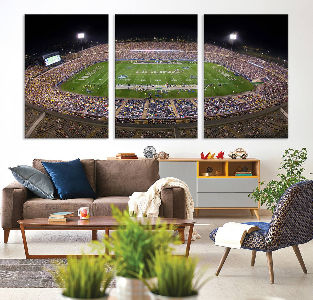 A large football stadium at night, featuring the UCONN Huskies, is depicted on the East Hartford Pratt & Whitney Stadium Wall Art Canvas Print.