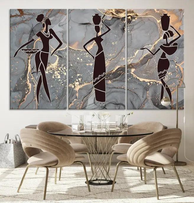 The Abstract African Women Silhouette Canvas Print is a 3-panel wall art with a gray marble texture and gold accents, enhancing the modern aesthetic of the room.