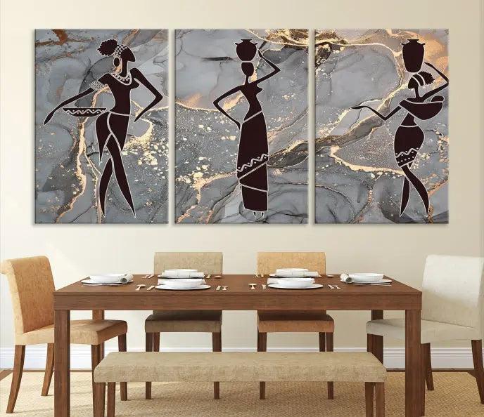 The Abstract African Women Silhouette Canvas Print is a 3-panel wall art with a gray marble texture and gold accents, enhancing the modern aesthetic of the room.