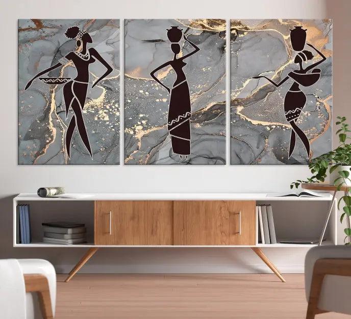 The Abstract African Women Silhouette Canvas Print is a 3-panel wall art with a gray marble texture and gold accents, enhancing the modern aesthetic of the room.