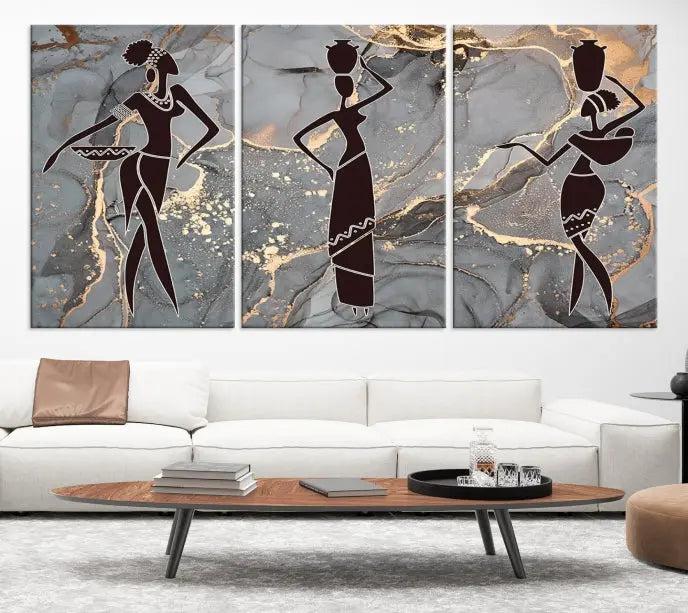 The Abstract African Women Silhouette Canvas Print is a 3-panel wall art with a gray marble texture and gold accents, enhancing the modern aesthetic of the room.