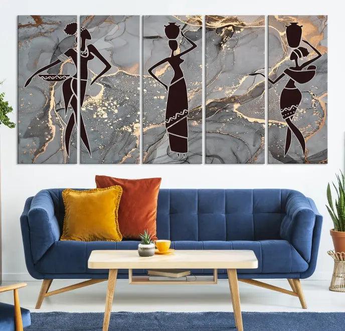 The Abstract African Women Silhouette Canvas Print is a 3-panel wall art with a gray marble texture and gold accents, enhancing the modern aesthetic of the room.