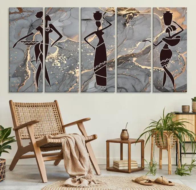 The Abstract African Women Silhouette Canvas Print is a 3-panel wall art with a gray marble texture and gold accents, enhancing the modern aesthetic of the room.