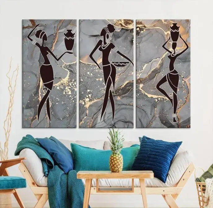 A canvas print titled "Abstract African Womens Art," with UV-protective coating, is displayed in three panels against a dark wall.