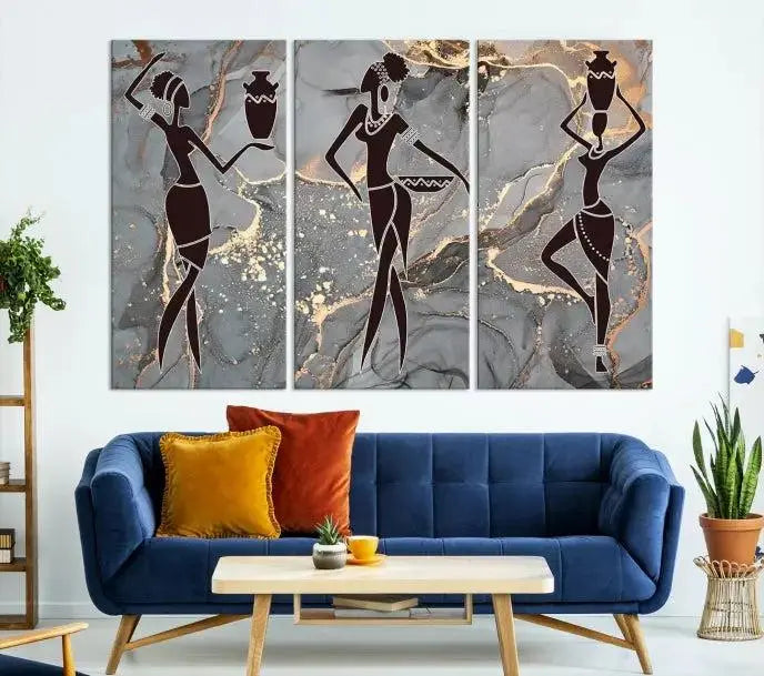 A canvas print titled "Abstract African Womens Art," with UV-protective coating, is displayed in three panels against a dark wall.