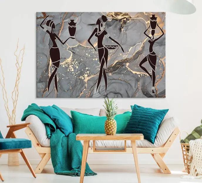 A canvas print titled "Abstract African Womens Art," with UV-protective coating, is displayed in three panels against a dark wall.