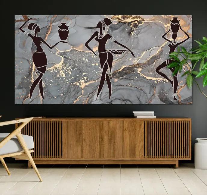 A canvas print titled "Abstract African Womens Art," with UV-protective coating, is displayed in three panels against a dark wall.