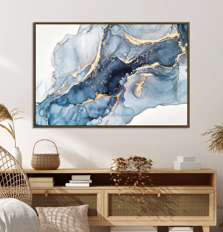 An abstract art print with fluid blue and gold hangs elegantly on the wall.