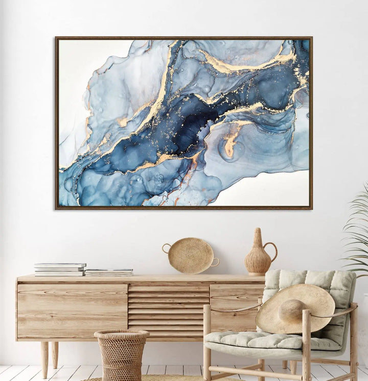 An abstract art print with fluid blue and gold hangs elegantly on the wall.