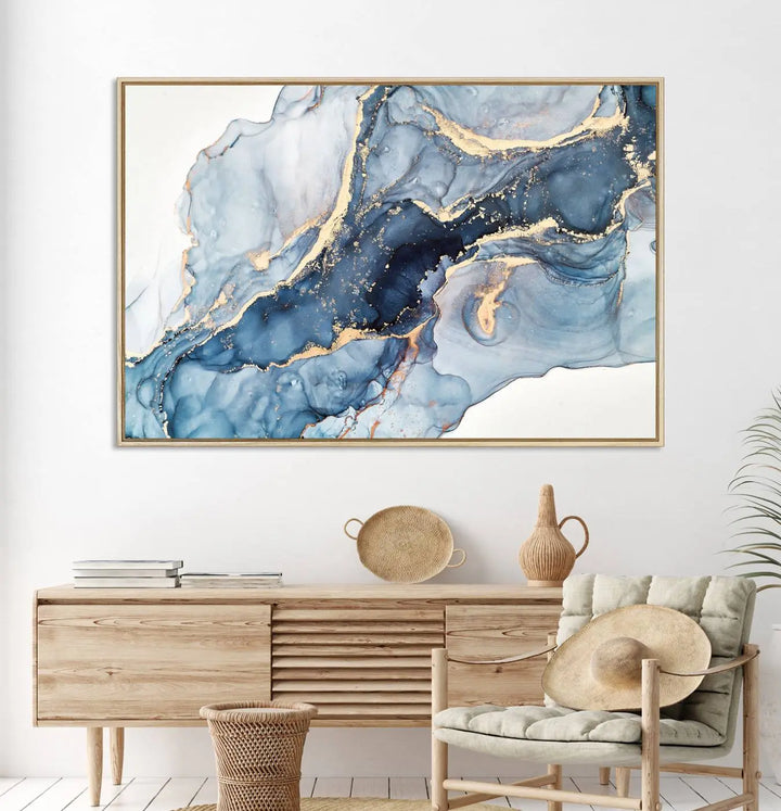 An abstract art print with fluid blue and gold hangs elegantly on the wall.