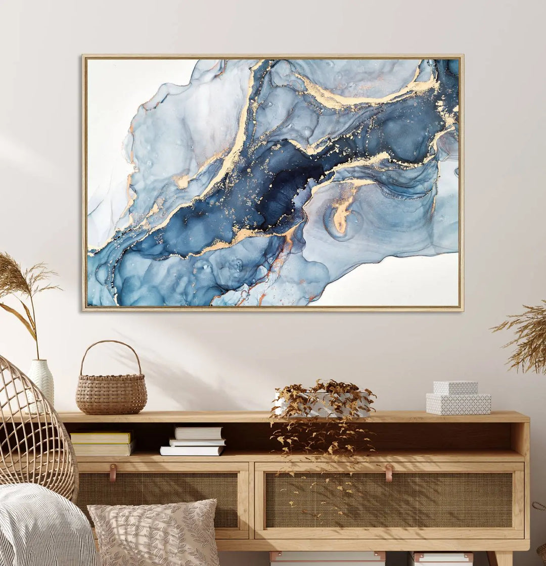 An abstract art print with fluid blue and gold hangs elegantly on the wall.