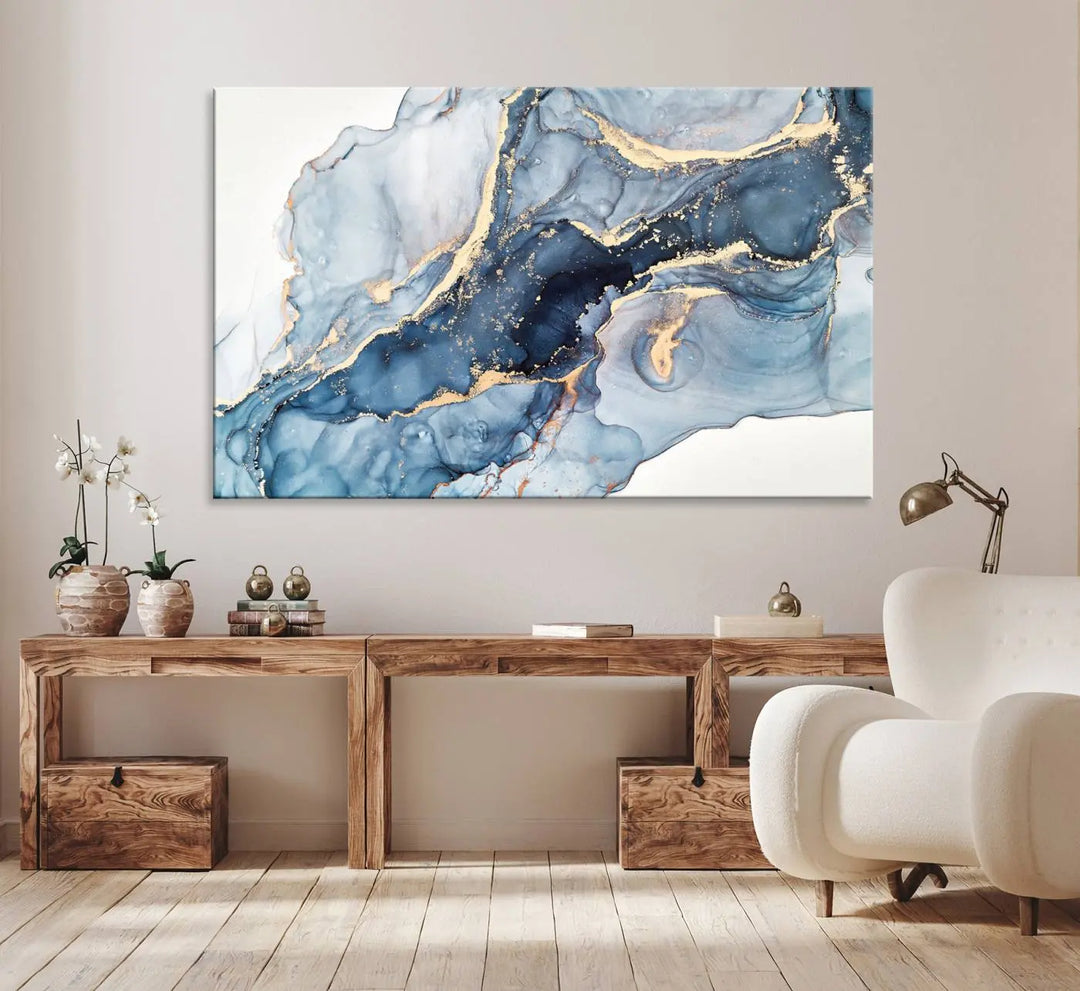 An abstract art print with fluid blue and gold hangs elegantly on the wall.