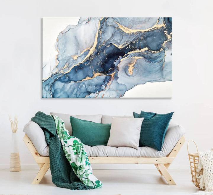 An abstract art print with fluid blue and gold hangs elegantly on the wall.