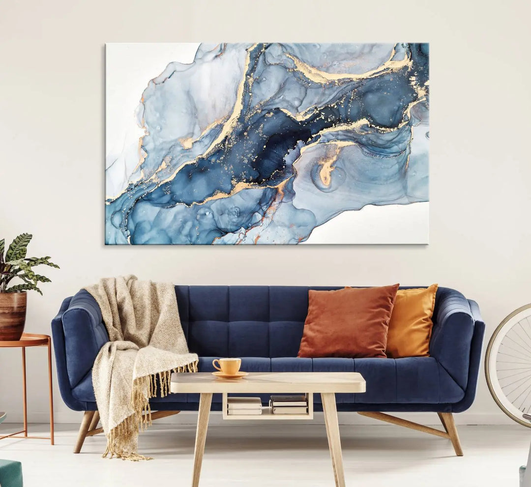 An abstract art print with fluid blue and gold hangs elegantly on the wall.