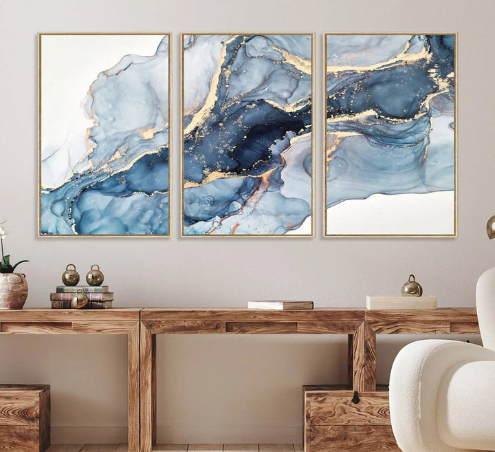 An abstract art print with fluid blue and gold hangs elegantly on the wall.