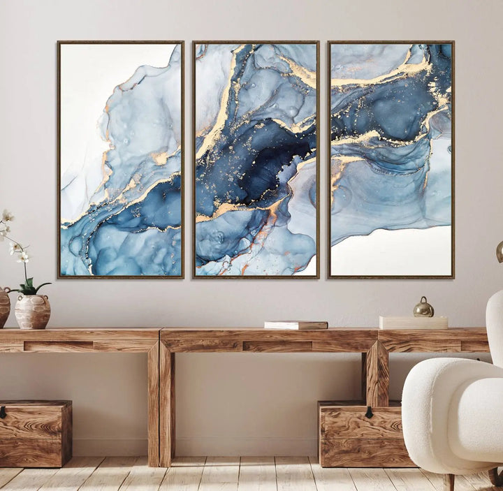 An abstract art print with fluid blue and gold hangs elegantly on the wall.