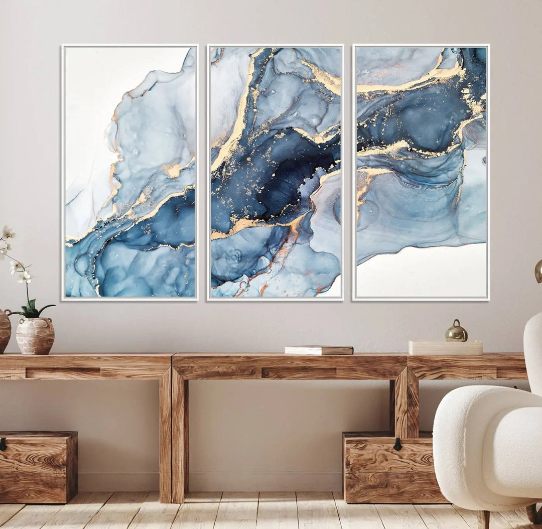 An abstract art print with fluid blue and gold hangs elegantly on the wall.