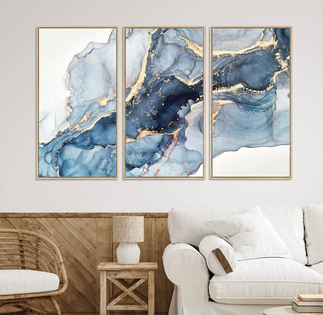 An abstract art print with fluid blue and gold hangs elegantly on the wall.