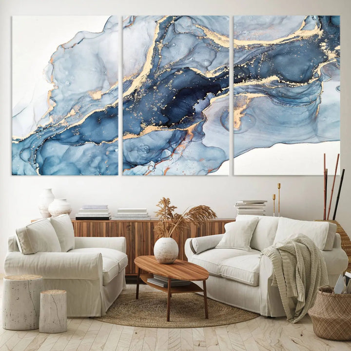 An abstract art print with fluid blue and gold hangs elegantly on the wall.