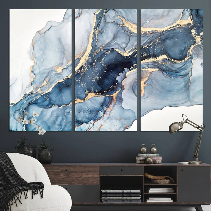 An abstract art print with fluid blue and gold hangs elegantly on the wall.