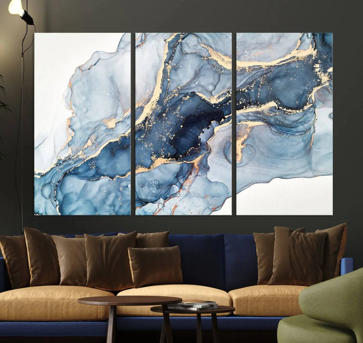 An abstract art print with fluid blue and gold hangs elegantly on the wall.