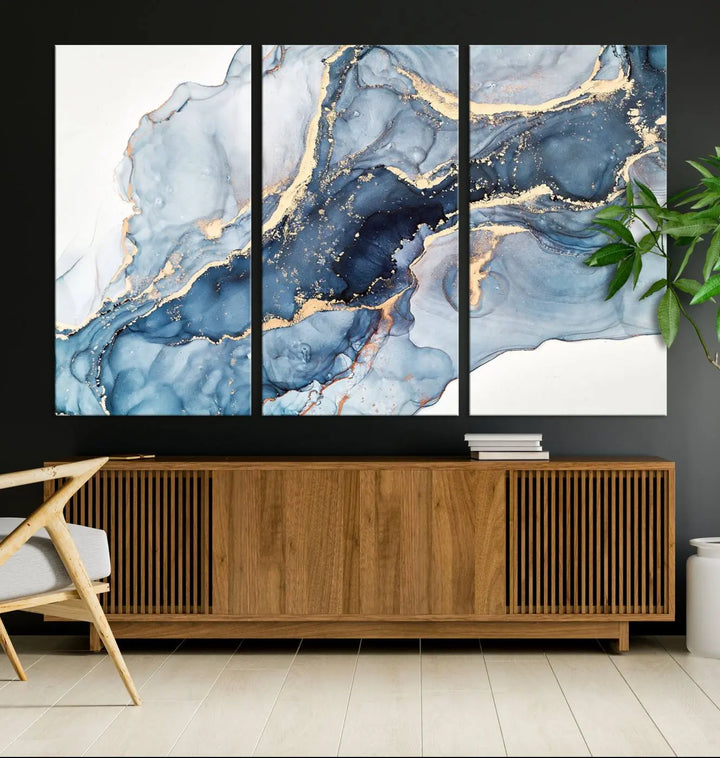 An abstract art print with fluid blue and gold hangs elegantly on the wall.