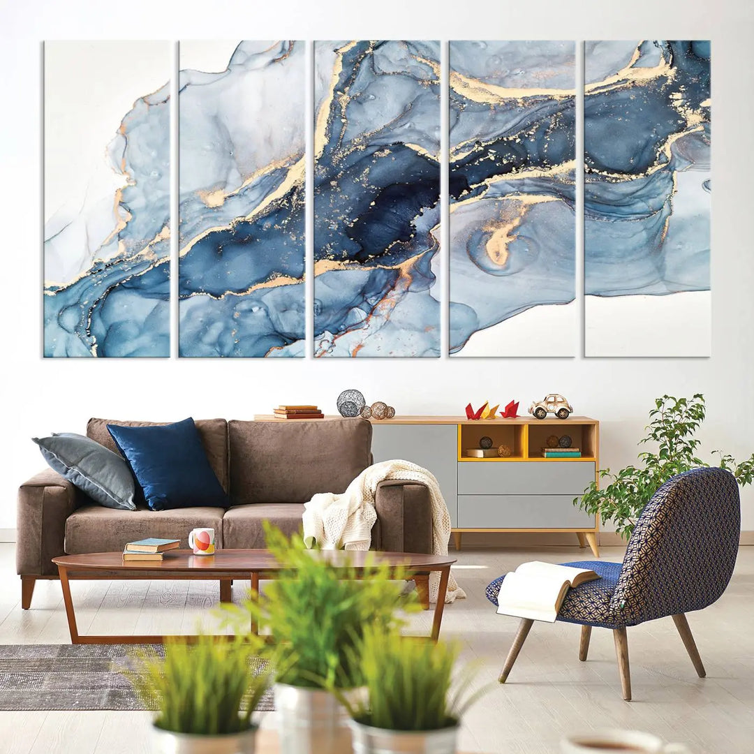 An abstract art print with fluid blue and gold hangs elegantly on the wall.