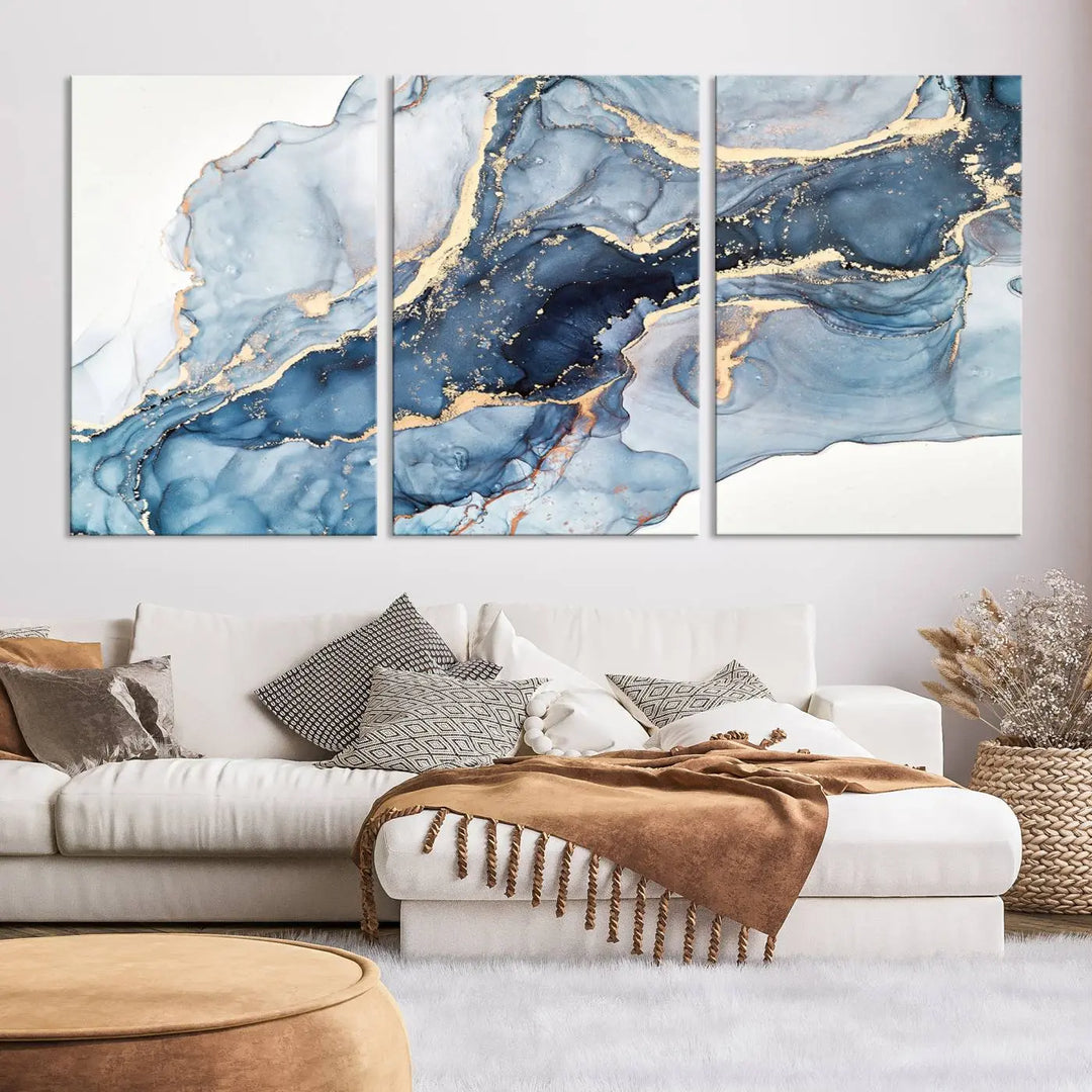 The living room showcases a striking Abstract Art Print - Blue Abstract Canvas Wall Art, featuring fluid effect artwork in vibrant blue and gold tones.